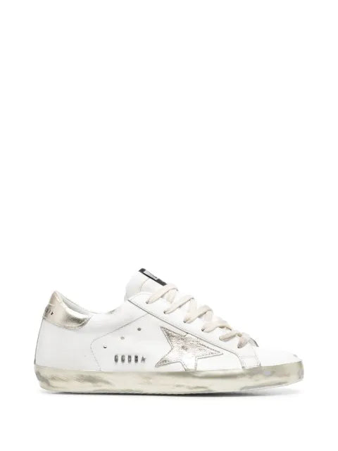 Golden Goose Super-Star trainers with gold sparkle foxing and metal stud lettering