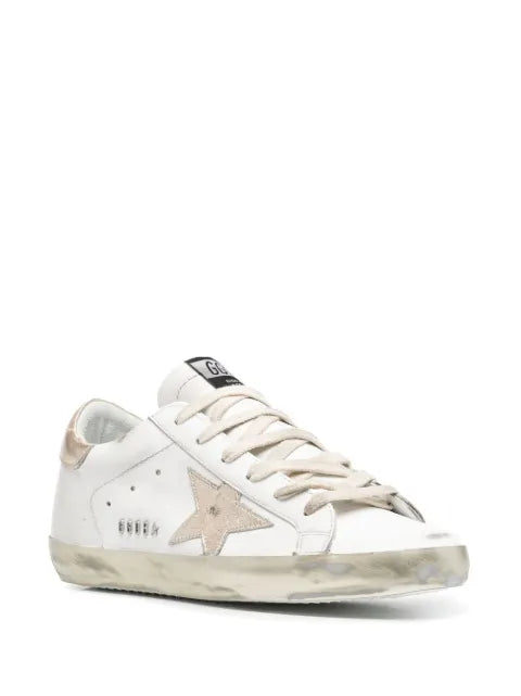 Golden Goose Super-Star trainers with gold sparkle foxing and metal stud lettering