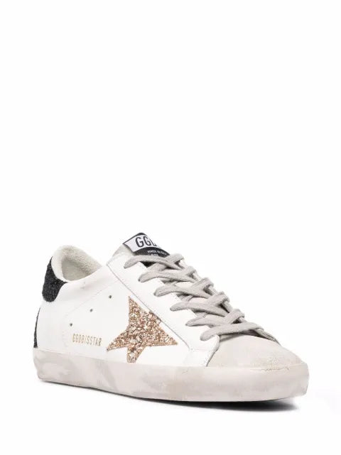 Golden Goose Super-Star trainers in nappa leather with gold glitter star and black glitter heels tab