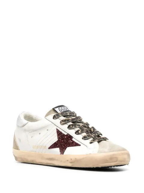 Golden Goose Super-Star trainers with burgundy glitter star and silver heels tab