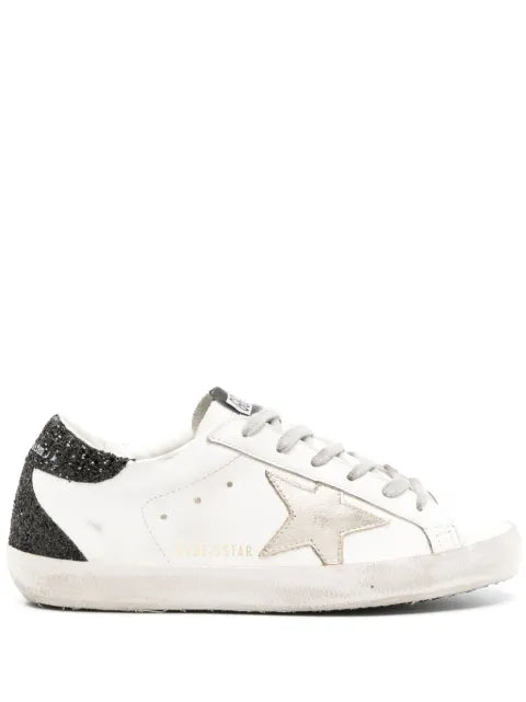 Golden Goose Super-Star trainers with gold star and black glitter heels tab