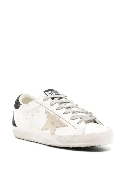 Golden Goose Super-Star trainers with gold star and black glitter heels tab